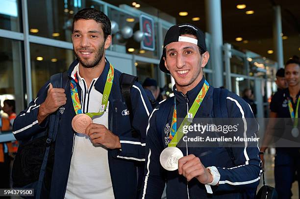 Mahiedine Mekhissi-Benabbad, 3000m steeplchase bronze medalist, and Sofiane Oumiha, light 60 kg boxing silver medalist, arrive at Roissy Charles de...