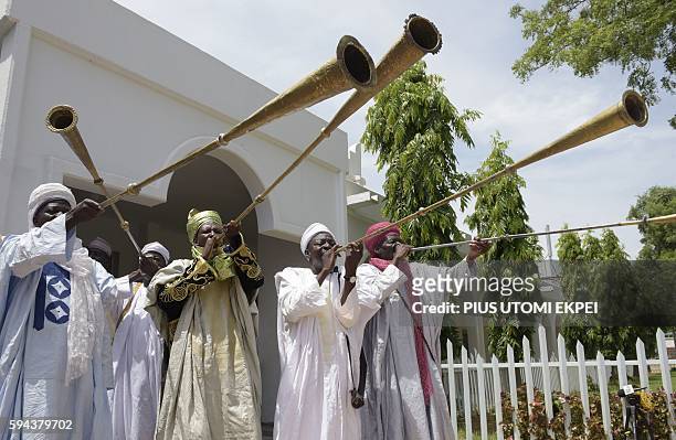 Traditional flutists perform to welcome US Secretary of State John Kerry at the palace of the Sultan of Sokoto on August 23, 2016 in Sokoto. Kerry...