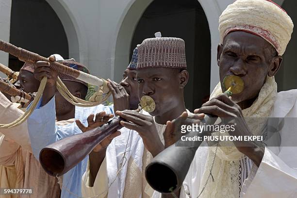 Traditional flutists perform to welcome US Secretary of State John Kerry at the palace of the Sultan of Sokoto on August 23, 2016 in Sokoto. Kerry...