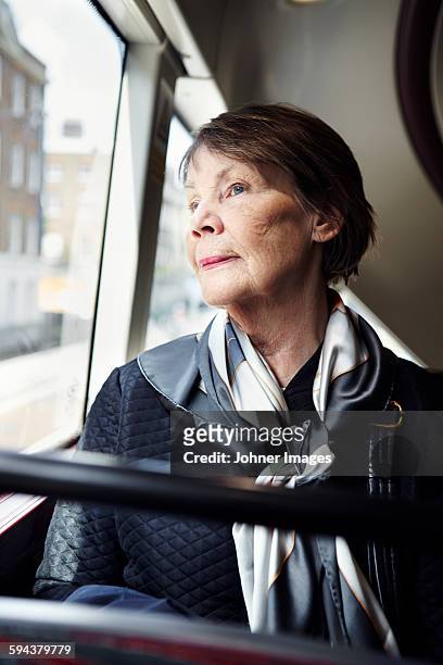 senior woman in bus - bus wrap stockfoto's en -beelden