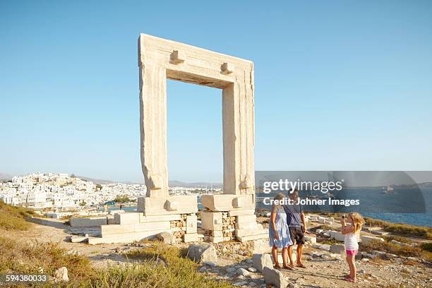 girl on holidays taking picture of her parents - naxos stock-fotos und bilder