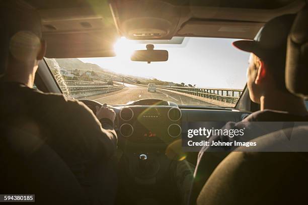 father with son driving in car - car interieur stock pictures, royalty-free photos & images