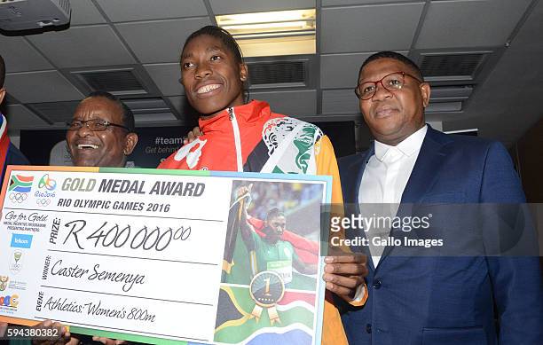 Gold medallist Caster Semenya is presented with a cheque at the OR Tambo airport during the arrival of the SA Athletics team from the 2016 Rio...