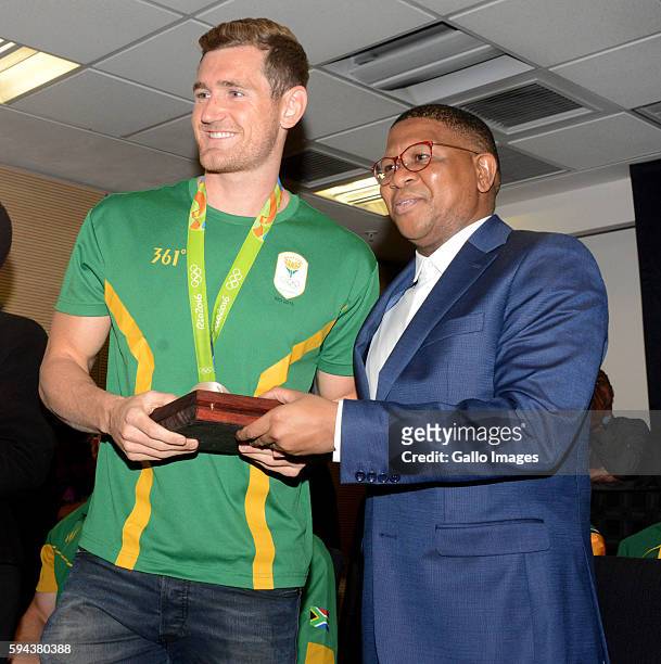 Sports and Recreation Minister Fikile Mbalula poses with Cameron van der Burgh at the OR Tambo airport during the arrival of the SA Athletics team...