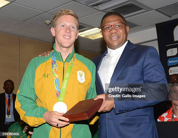 Sports and Recreation Minister Fikile Mbalula poses with silver medallist Henri Schoeman at the OR Tambo airport during the arrival of the SA...