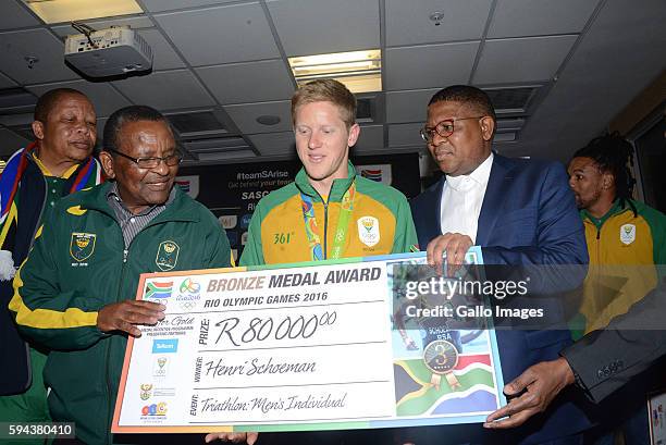 Bronze medallist Henri Schoeman is presented with a cheque at the OR Tambo airport during the arrival of the SA Athletics team from the 2016 Rio...