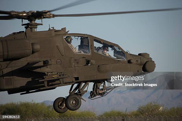 ah-64d apache longbow lifts off on a mission during exercise angel thunder 2013. - arizona angel thunder fotografías e imágenes de stock