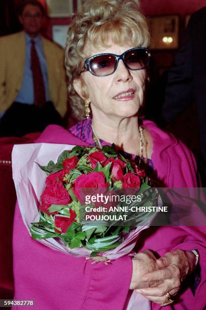 Picture taken on May 12, 1995 shows French actress Jacqueline Pagnol holding a bouquet at the opening ceremony of an exhibition dedicated to his...