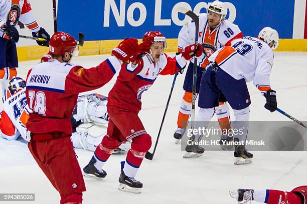 Players of Yunost-Minsk Andrei Mikhnov and Alexander Karakulko celebrate 1st score to goal Vaxjo Lakers during the game skate of the Champions Hockey...