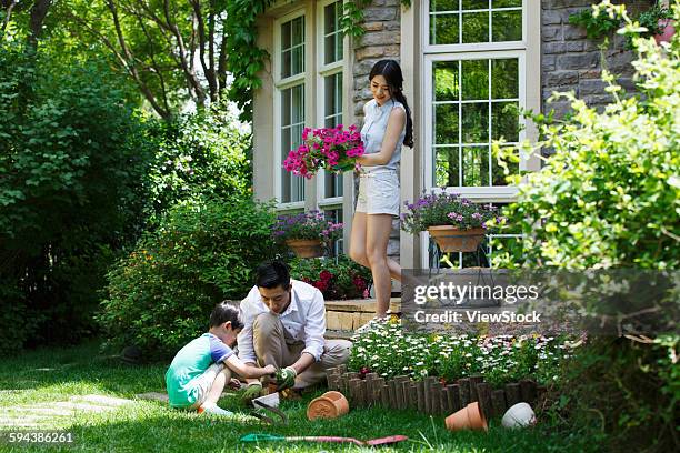 happy family in the garden - flower etnic stock pictures, royalty-free photos & images