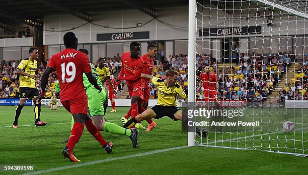 Divock Origi of Liverpool scores the opening goal during the EFL Cup match between Burton Albion and Liverpool at the Pirelli Stadium on August 23,...
