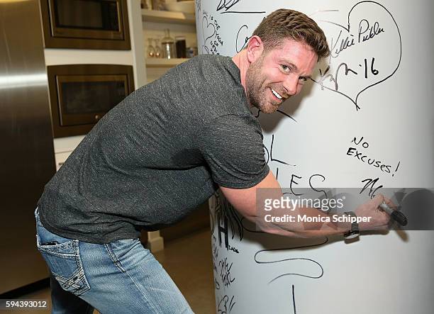 United States Army veteran and motivational speaker Noah Galloway signs the wall at AOL HQ when he visits for AOL Build Presents Noah Galloway...