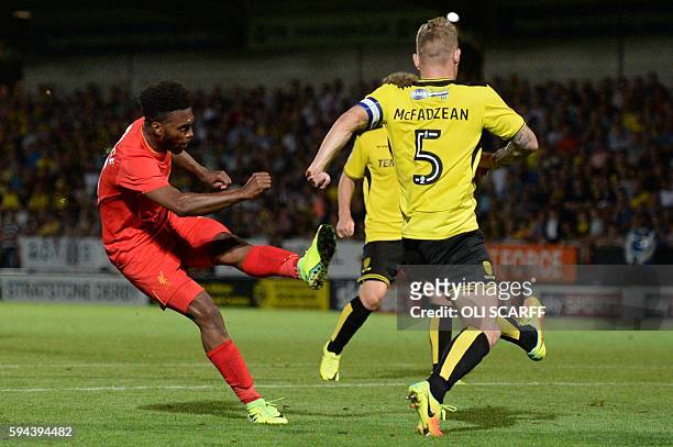 Liverpool's English striker Daniel Sturridge scores Liverpool's fifth goal during the English League Cup second round football match between Burton...