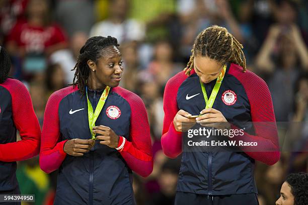 Summer Olympics: USA Tina Charles and Brittney Griner victorious with gold medals on the podium after defeating Spain in Women's Final - Gold Medal...