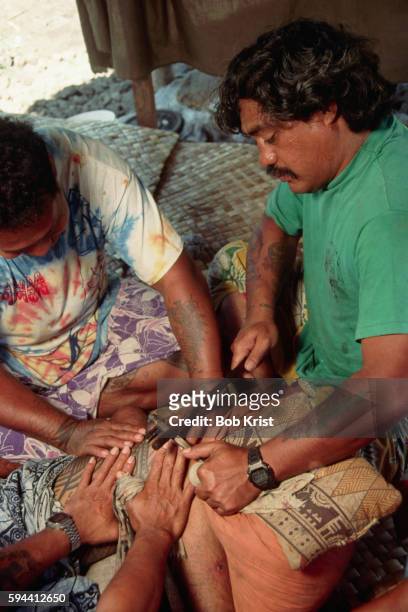samoan man being tattooed - western samoa stock pictures, royalty-free photos & images