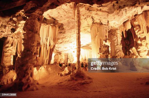 visitors standing inside the cango caves - cango caves stock pictures, royalty-free photos & images