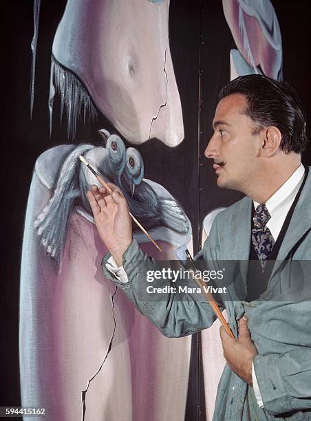 The surrealist painter Salvador Dali works on the figure of two birds in a large oil composition, Greenwich Village, New York.