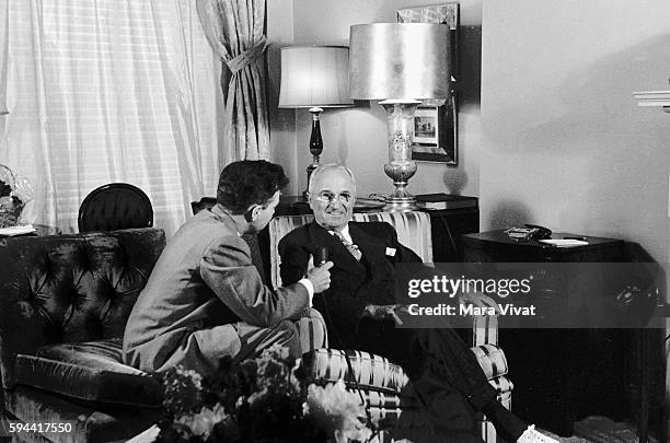 Former president Harry Truman gives an interview to a reporter in a sitting room. After his presidency ended in 1953, Truman retired to his hometown...