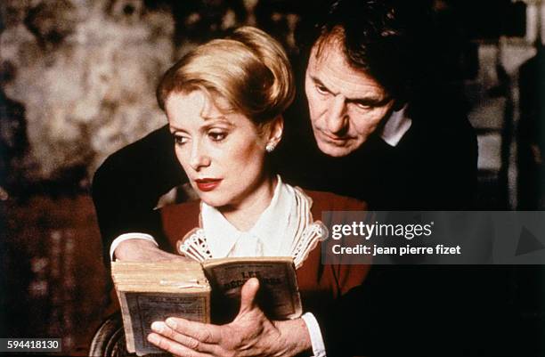 French actress Catherine Deneuve and German actor Heinz Bennent on the set of Le Dernier Métro, written and directed by François Truffaut.