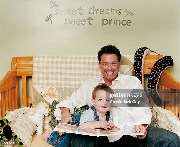 Game show host Todd Newton is photographed with son Mason for InTouch Weekly in 2003 at home in Los Angeles, California. PUBLISHED IMAGE.