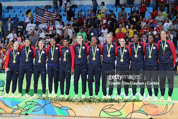Basketball - Olympics: Day 15 Unites States players celebrate on the podium after receiving their gold medals, from left, Lindsay Whalen, Seimone...