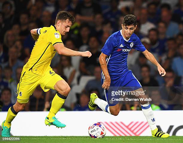 Tom Lockyer of Bristol Rovers and Oscar of Chelsea in action during the EFL Cup second round match between Chelsea and Bristol Rovers at Stamford...