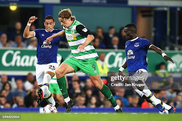 Tom Eaves of Yeovil Town takes on Ramiro Funes Mori of Everton during the EFL Cup second round match between Everton and Yeovil Town at Goodison Park...