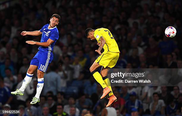 Eden Hazard of Chelsea wins a header with Daniel Leadbitter of Bristol Rovers during the EFL Cup second round match between Chelsea and Bristol...