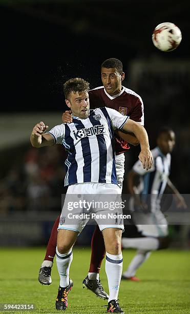 Lewin Nyatanga of Northampton Town contests the ball with Rickie Lambert of West Bromwich Albion during the EFL Cup second round match between...