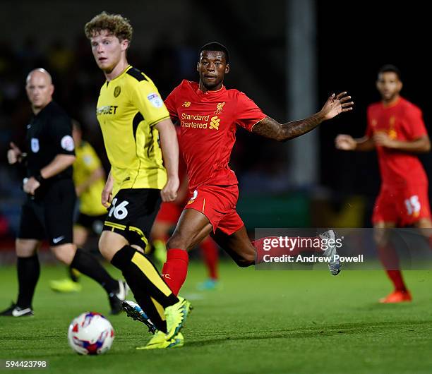 Georginio Wijnaldum of Liverpool competes with Jackson Irvine of Burton Albionduring the EFL Cup match between Burton Albion and Liverpool at the...