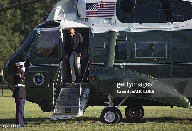 President Barack Obama exits Marine One upon arrival on the South Lawn of the White House in Washington, DC, August 23 after traveling to Baton...