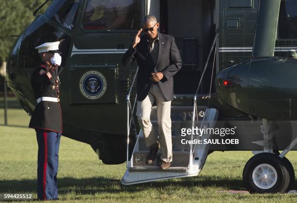 President Barack Obama exits Marine One upon arrival on the South Lawn of the White House in Washington, DC, August 23 after traveling to Baton...