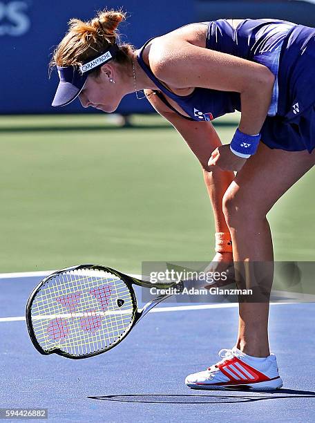 Belinda Bencic of Switzerland smashes her racket during her match against Kirsten Flipkens of Belgium on day 3 of the Connecticut Open at the...