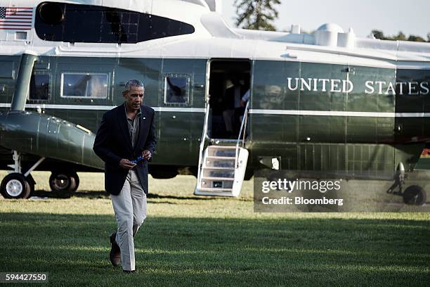 President Barack Obama walks away from Marine One on the South Lawn as he returns to the White House in Washington, D.C. On Tuesday, Aug. 23, 2016....