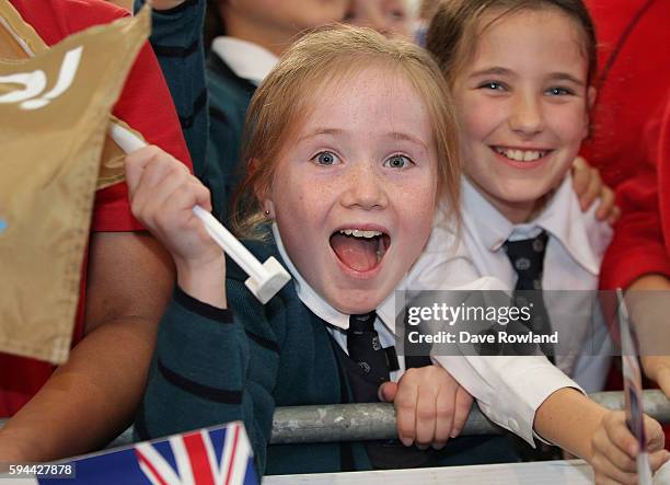 Schoolchildren welcome the athletes during the New Zealand Olympic Games athlete home coming at Auckland International Airport [OR] The Cloud on...