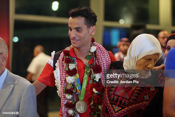 Medallist is seen with his mother during a ceremony to welcome home Jordanian Olympic gold medallist Ahmad Abu Goush and other olympic mission...