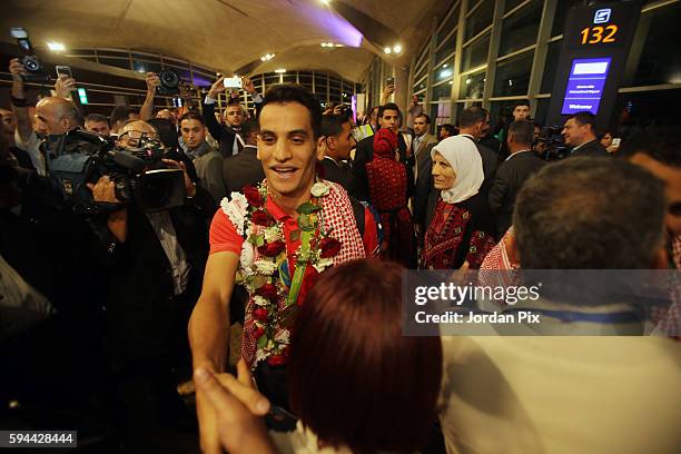 Jordanian Olympic gold medallist Ahmad Abu Goush is welcomed upon his arrival with other olympic mission members at Queen Alia International Airport...