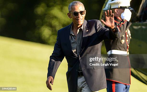 President Barack Obama walks toward the White House after exiting Marine One upon his arrival from Baton Rouge, Louisiana on August 23, 2016 in...