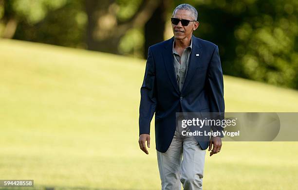 President Barack Obama walks toward the White House after exiting Marine One upon his arrival from Baton Rouge, Louisiana on August 23, 2016 in...