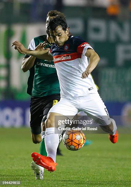 Alberto Facundo Costa of San Lorenzo fights for the ball with Nicolas Santiago Bertolo of Banfield during a first leg match between Banfield and San...