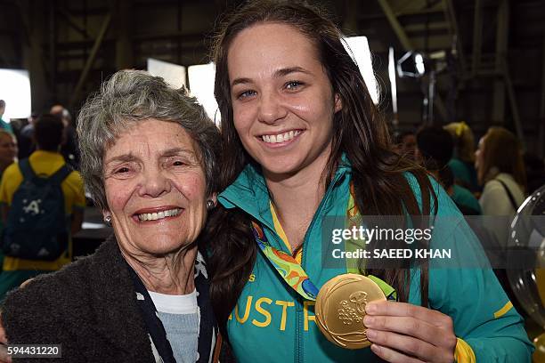 Family member greets Australian Rugby player Chloe Dalton upon her arrival with other members of the Rio Olympic team in Sydney on August 24, 2016....