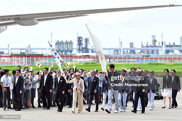 The governor of Tokyo Yuriko Koike with the Olympic flag, Rio de Janeiro Olympic Japan squad Sub-captain Keisuke Ushiro with the JOC flag, and Team...