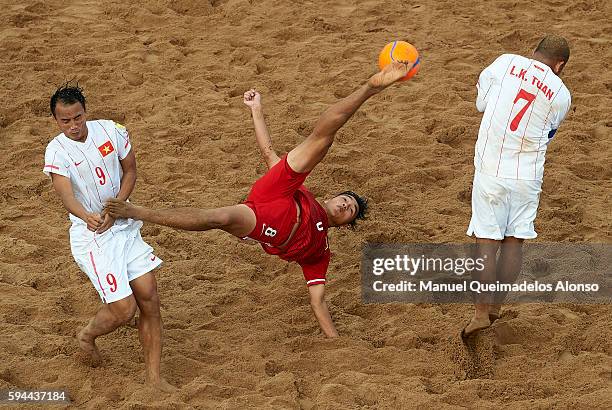 Cai Wei Ming of China attempts a scissor kick shot on goal in front Le Kim Tuan and Train Vinh Phong of Vietnam during the Continental Beach Soccer...