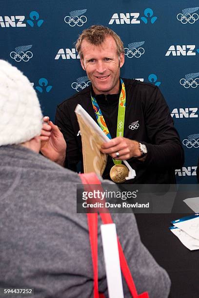 Mahe Drysdale's gold medalist in the singles sculls signs autographs during the New Zealand Olympic Games athlete home coming at Auckland...