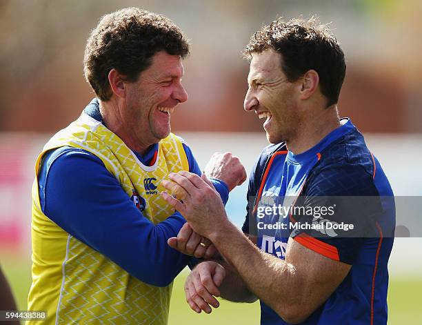 Brent Harvey of the Kangaroos, not to be re-contracted for next season by the club, reacts with assistant coach Leigh Tudor during a North Melbourne...