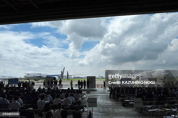 Planes stand on the tarmac during the official flag arrival ceremony at the Tokyo's Haneda airport on August 24, 2016. The Olympic flag arrived in...