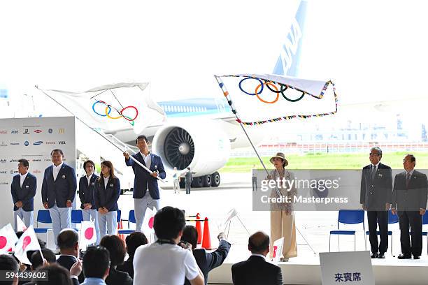 Tokyo Governor Yuriko Koike with the Olympic flag,and Rio de Janeiro Olympic Japan squad Sub-captain Keisuke Ushiro the JOC flag, waves during the...