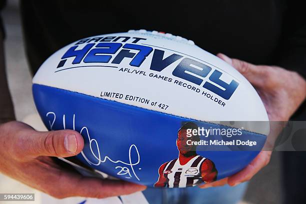 Football of Brent Harvey of the Kangaroos, not to be re-contracted for next season by the club, is held by a fan during a North Melbourne Kangaroos...