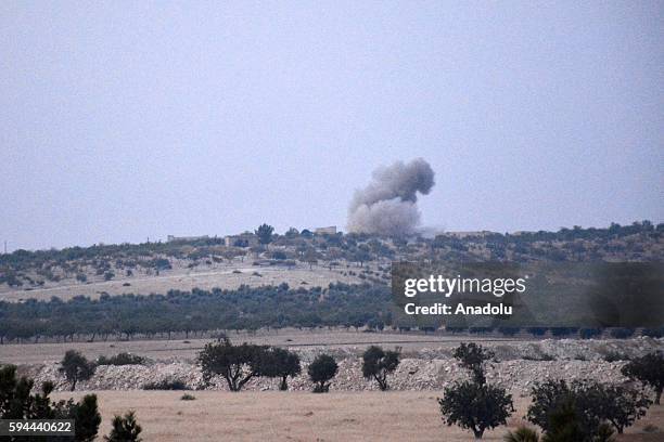 The photo taken from Karkamis district of the Turkey's Gaziantep province shows smoke rising as the Turkish fighter jets bomb Daesh targets in...