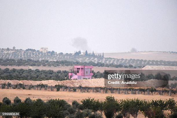 The photo taken from Karkamis district of the Turkey's Gaziantep province shows smoke rising as the Turkish fighter jets bomb Daesh targets in...